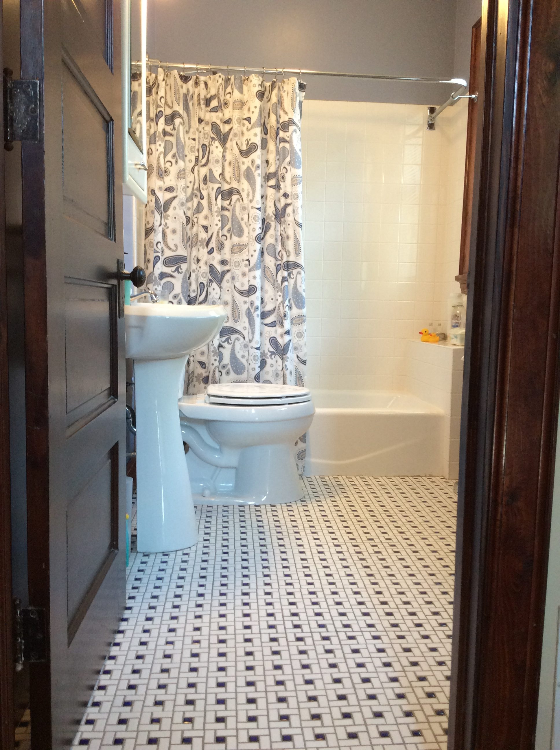 Fresh, clean tiled bathroom with rain shower head.
